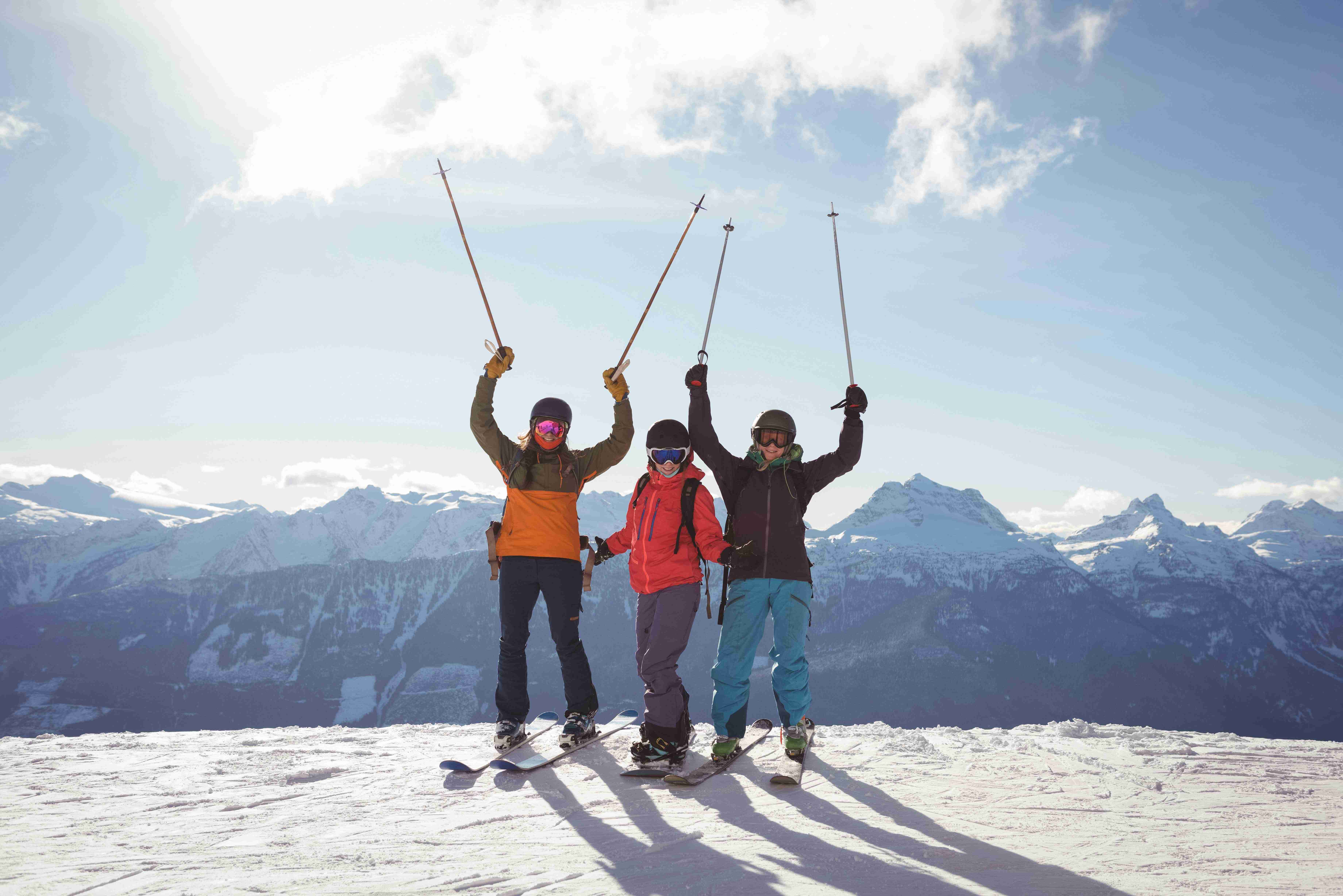 celebrating-skiers-standing-snow-covered-mountain (1)-min (1) (1) (1)