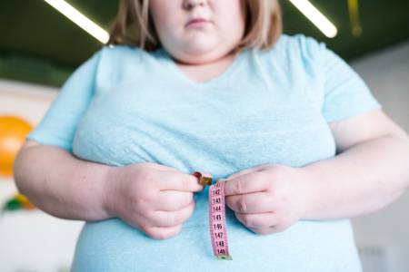 obese-woman-measuring-waist-2023-11-27-05-00-18-utc
