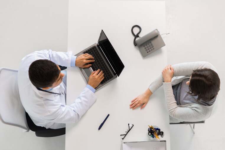doctor-with-laptop-and-woman-patient-at-hospital-2021-08-26-22-49-31-utc-min (1)