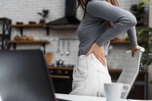 side-view-woman-having-backache-while-working-from-homev2