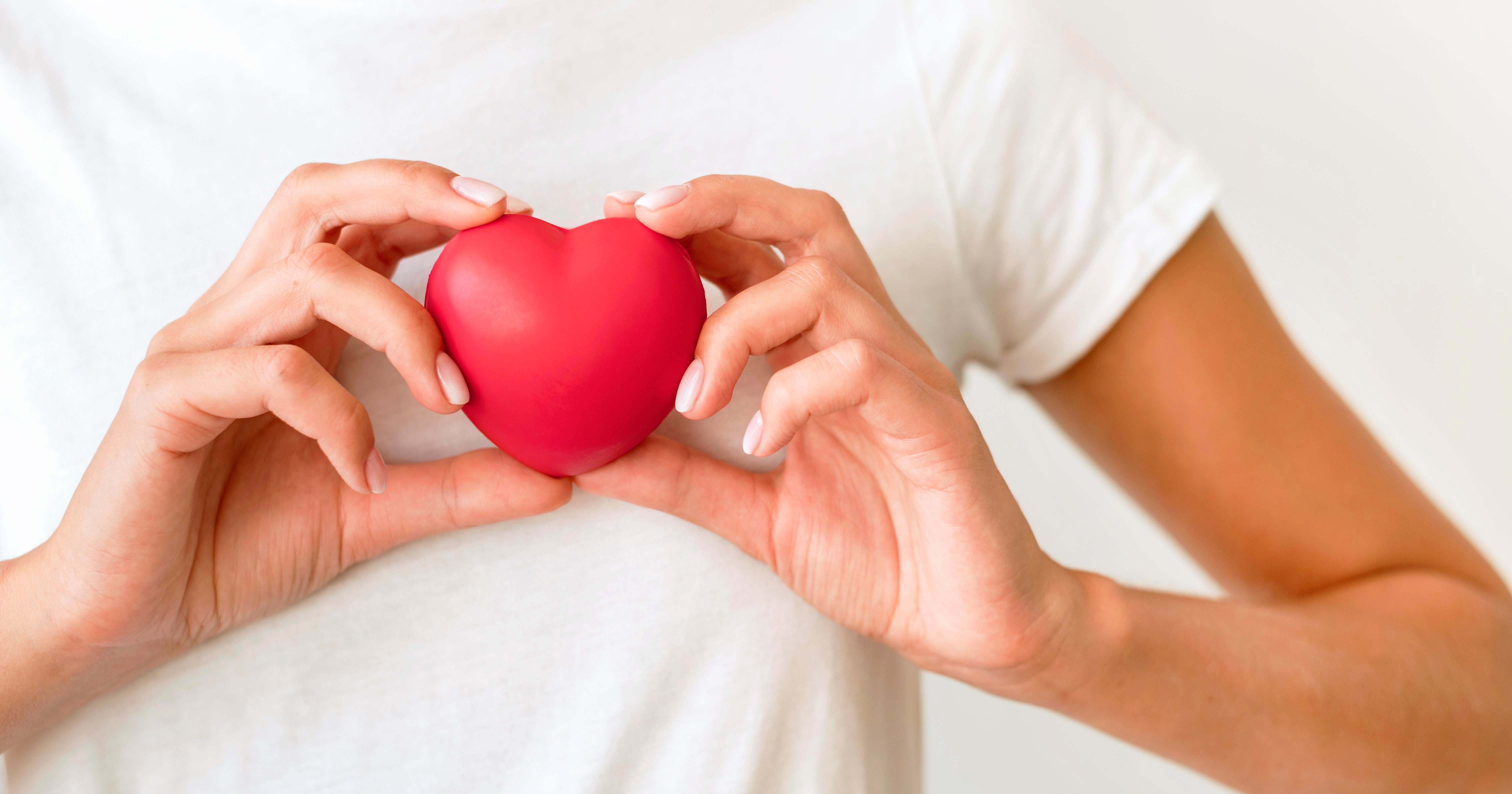 front-view-woman-holding-heart-shape