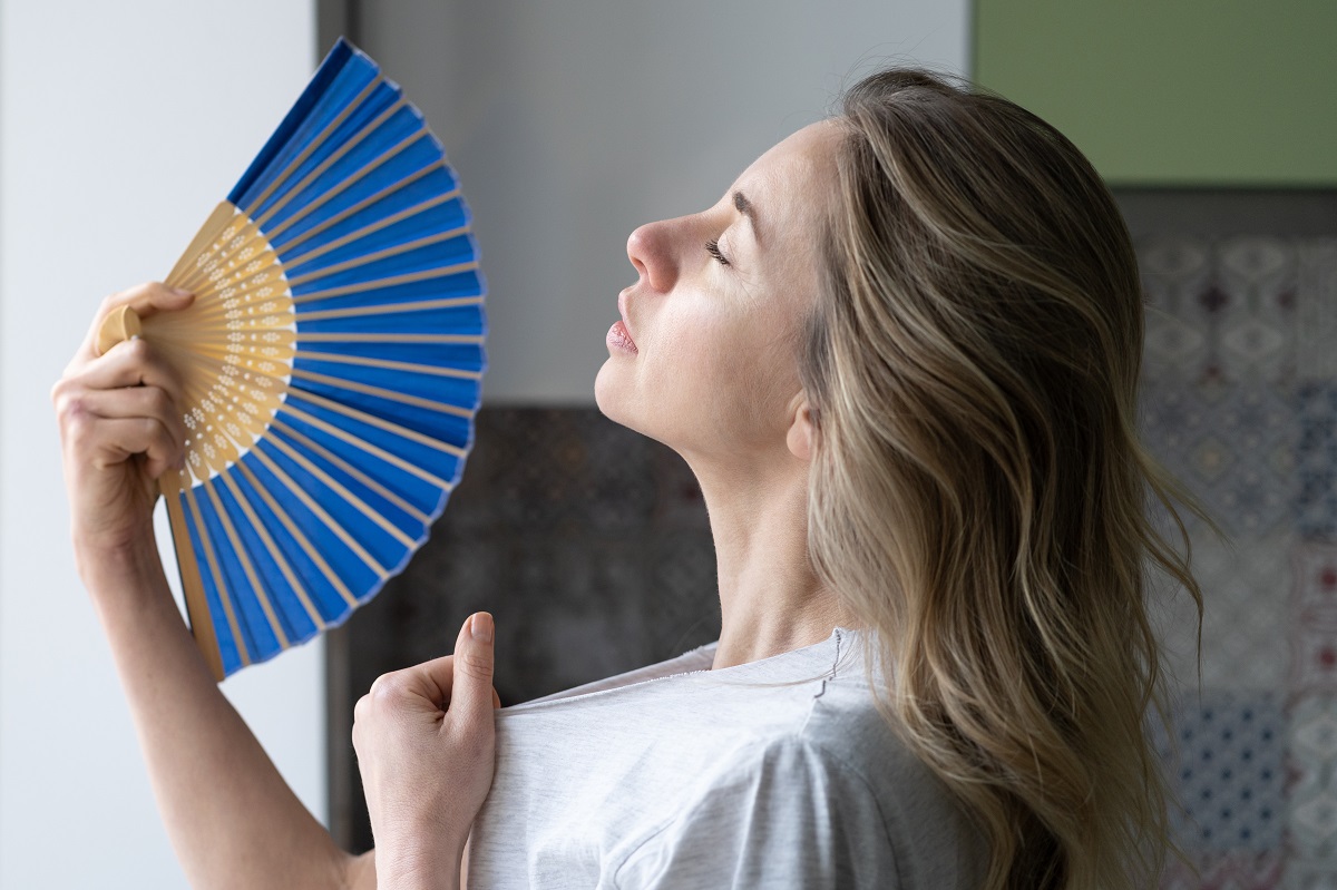 overheated-woman-in-t-shirt-using-wave-fan-suffer-2023-11-27-05-16-14-utc