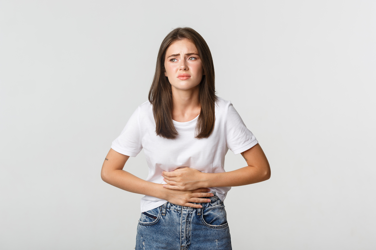 woman-having-stomach-ache-bending-with-hands-belly-discomfort-from-menstrual-cramps (1)