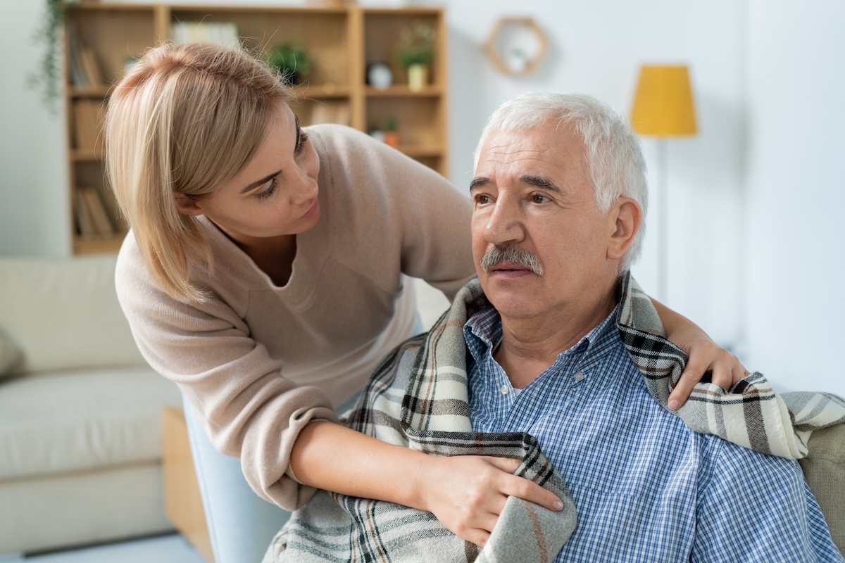 caring-woman-comforts-senior-man-at-home-2026-03-20-03-06-20-utc