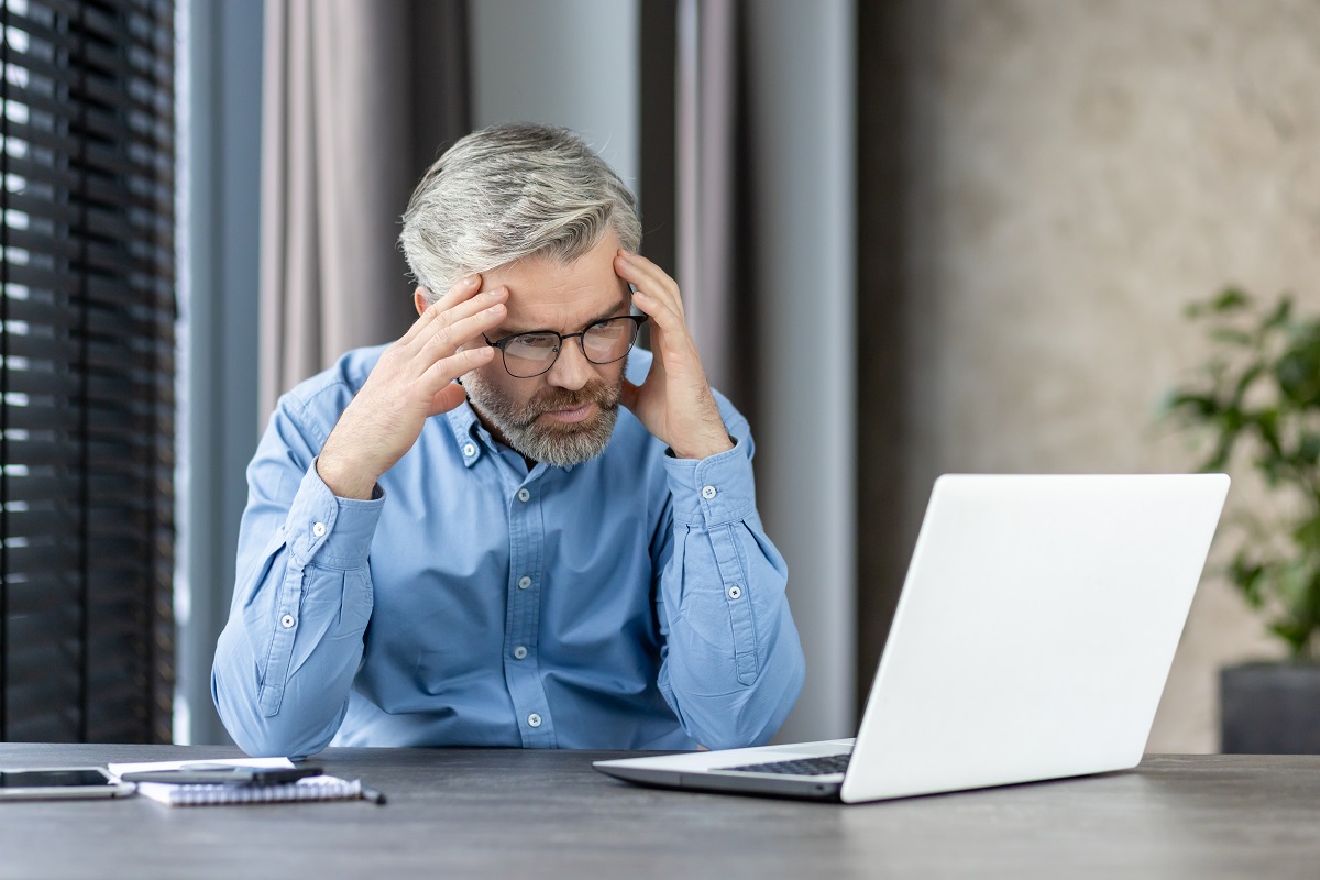 stressed-businessman-working-on-laptop-overwhelme-2024-07-15-18-15-49-utc