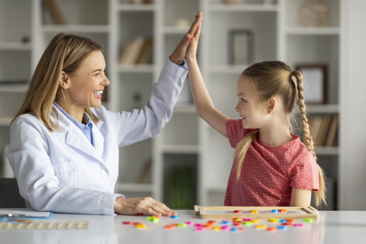 development-specialist-and-child-giving-high-five-2025-03-18-18-20-05-utc